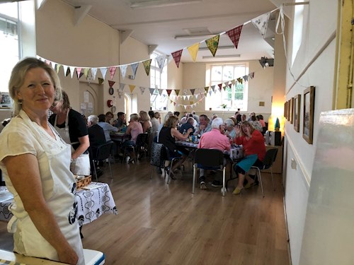 People enjoying themselves at a cream tea event at Poughill Village Hall