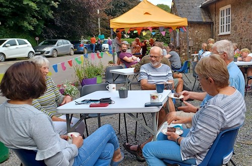 Stoodleigh Parish Hall car park in the sunshine doubles up as space to enjoy tea and cake