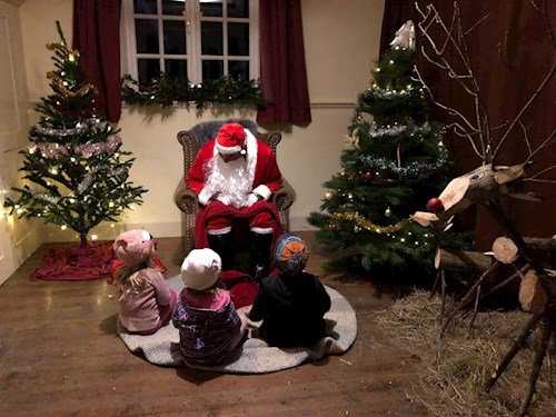 Santa and the kids in his parish hall grotto