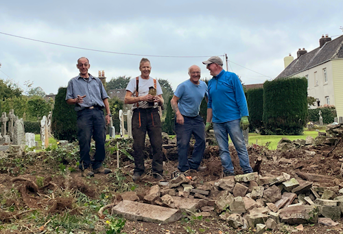 Volunteers prepare the ground for the rebuild of the wall