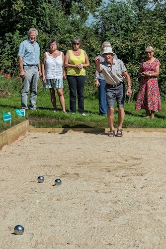 Image of the inaugural petanque match in progress.